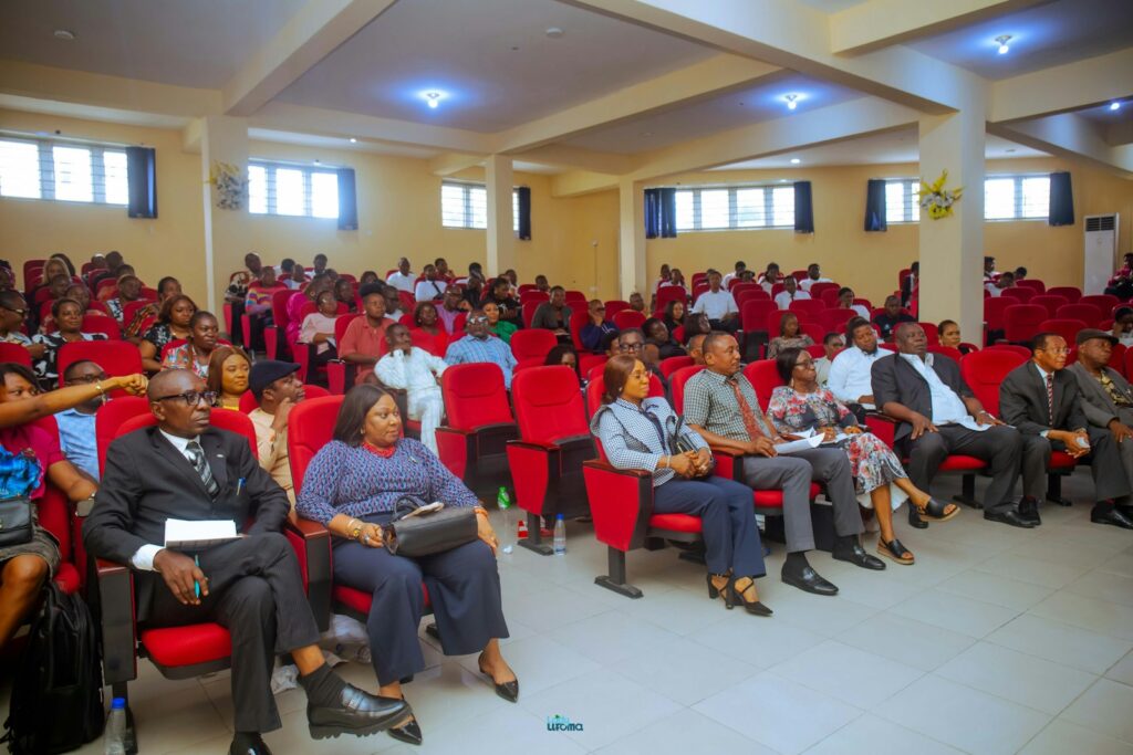 People attending a conference in a large auditorium, the kind of event that can be made greener