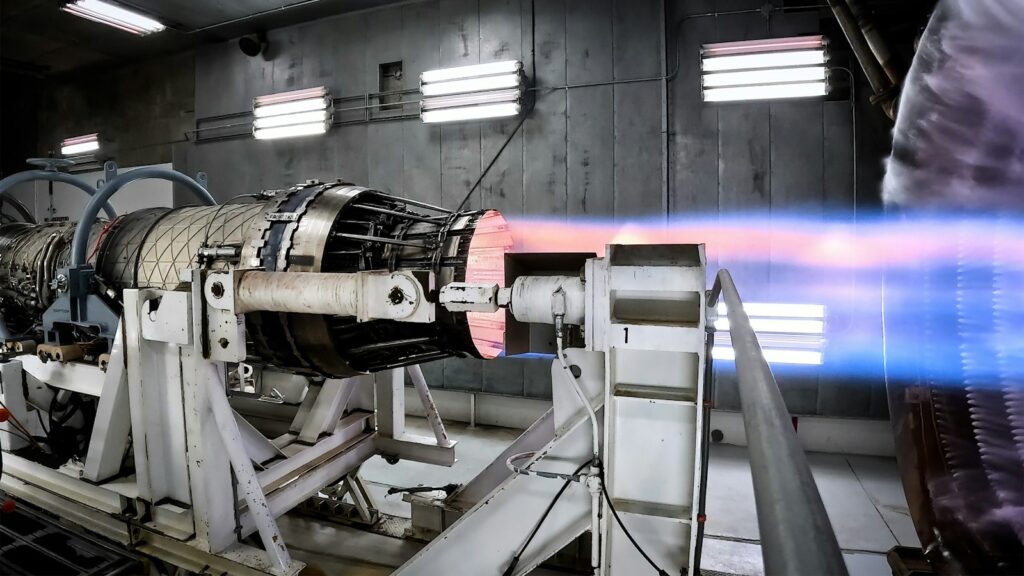 Turbine engine on a test stand inside a building, representing high temperature components